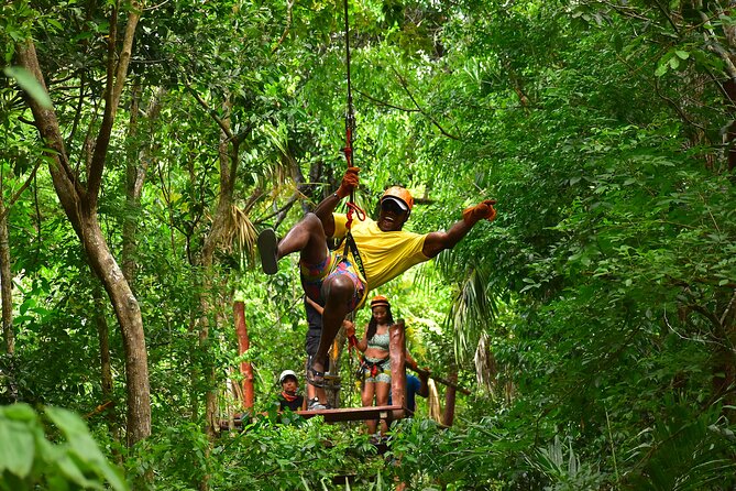 ATV Tour with Cenote swim, Ziplines, Transportation and Lunch Included - Ziplining above the Puerto Morelos jungle