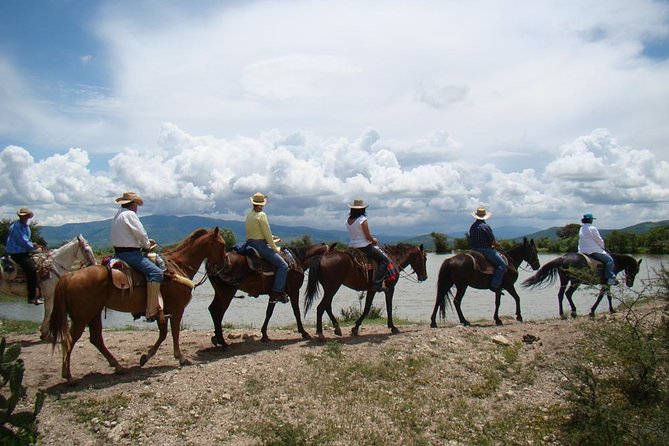 Half-Day Horseback Riding Adventure - Climbing toward the 150-foot canyon cliffs